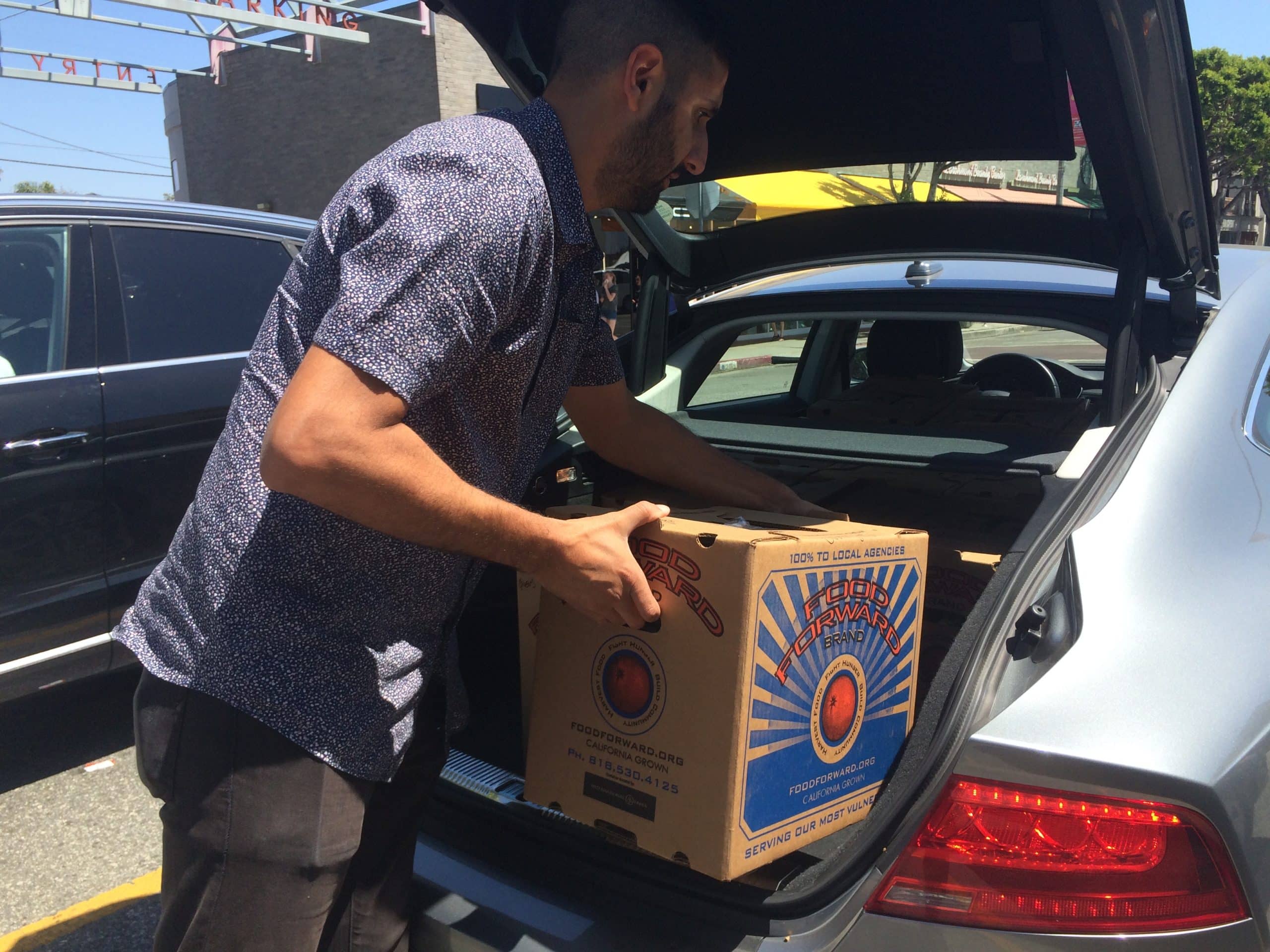 A Volunteer from PATH picks up the donation at the Larchmont Farmers Market